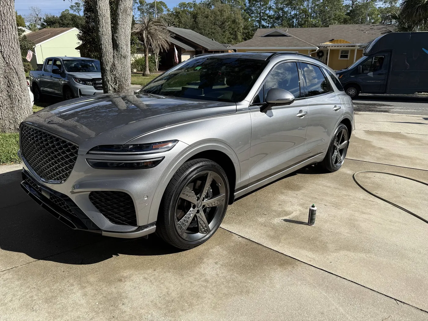 Silver Genesis GV70 freshly detailed in a Jacksonville driveway by Sud Titan mobile detailing