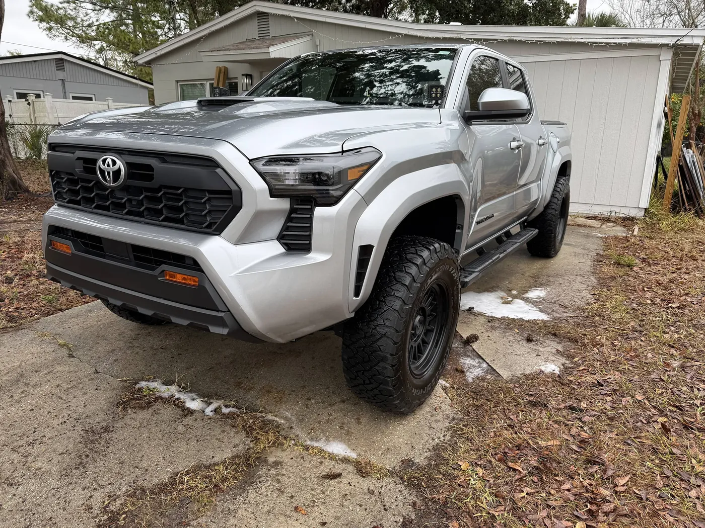 Silver Toyota Tacoma TRD with clean lifted tires after a mobile truck detail in Jacksonville